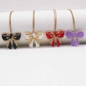 Handmade Miyuki bead bow necklaces in black, white, red, and purple with gold chains
