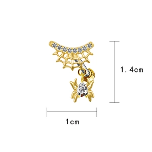 Detailed macro view of a golden spider belly ring with white zircon stones 1x1.4cm