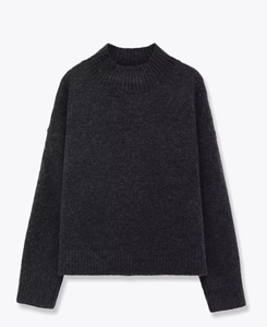 Detail view of dark grey knit sweater with ribbed cuffs and textured wool blend fabric