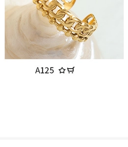 Macro shot of gold-plated ring with chain texture and beaded double-layer design