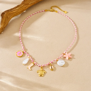 Detail of pink woven cord charm necklace with golden turtle and starfish pendants