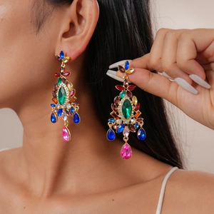 Macro detail of luxury vintage drop earrings featuring multicolor teardrop crystals