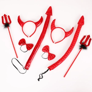 Detail view of red devil costume set with horns, trident and bow tie for Halloween