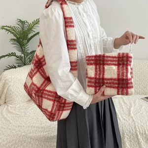 Detail of red and white plaid plush shoulder bag set with soft faux fur texture for winter