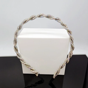 Detail of twisted headband with rainbow rhinestones and black cloth tips