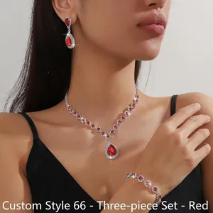 Close-up of red teardrop gemstone jewelry set including necklace, bracelet and earrings