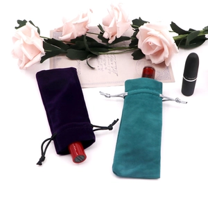 Velvet drawstring jewelry pouches in purple and green for lipstick storage