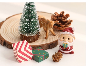 Detailed view of Christmas resin miniature set featuring Santa and reindeer on wood