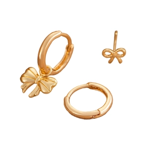 Three-piece gold bow pendant earrings set featuring hoop and stud styles on white backdrop