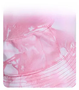 Detail of pink tie-dye bucket hat showing lafite grass texture and wide brim sun protection