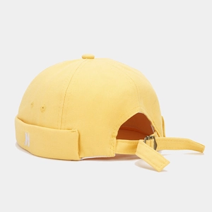 Detail of yellow cotton docker hat with white N embroidery and adjustable rear strap