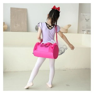Close-up of pink children's ballet bag with mesh ruffles and bow details shown on model