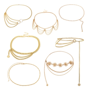 Retro multilayered gold chain body belts with sun and coin pendants on white background