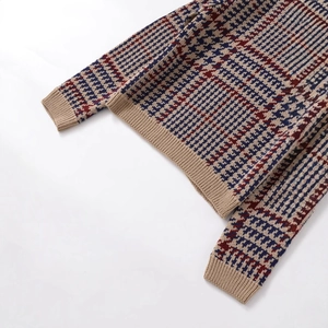 Fashionable houndstooth knit sweater in blue, red, and camel with ribbed hem details