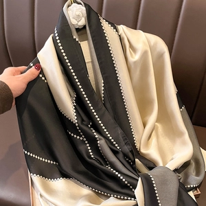 Elegant faux silk scarf in black and champagne gold with geometric diamond patterns