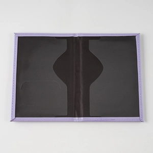 Close-up of purple leather passport holder with black interior slots and precise stitching