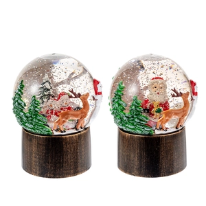 Boule à neige de Noël avec Père Noël et rennes sur un socle en bronze décoratif