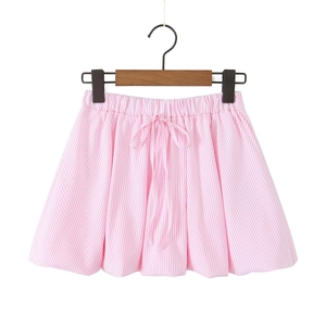 Detail of pink and white striped puff skirt with elastic waist and decorative bow tie