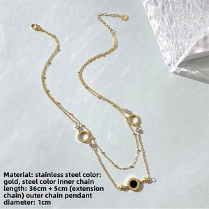Macro detail of gold-plated double-layer necklace with Roman numerals and open circles