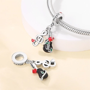Silver guitar and treble clef music charms with red rose detail on snake chain bracelet