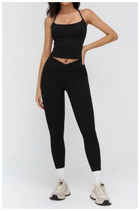 Detail of high-waisted black yoga pants featuring a slimming V-shaped cross waistband
