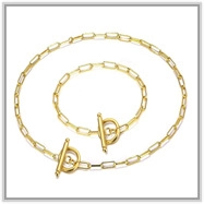 Detailed shot of golden flower paperclip chain necklace and bracelet set with T-bar closures