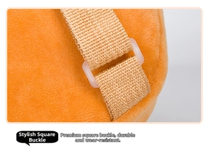 Detail of the orange plush backpack showing a transparent plastic buckle and nylon strap