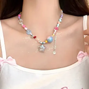 Detail of colorful beaded choker necklace with a glittery silver star pendant charm