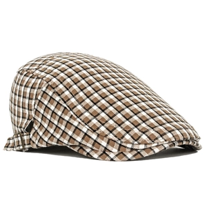 Detail of British plaid beret with brown checkered texture and bronze metal buckle