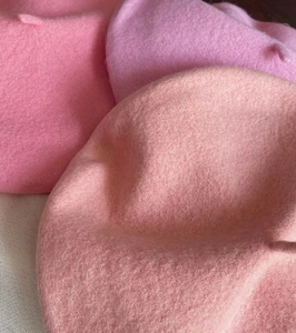 Close-up of thick wool felt beret showing soft pink color and premium fuzzy texture