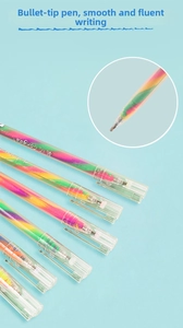 Detail of bullet tip and transparent barrel showing gradient rainbow ink in gel pens