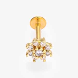 Detailed macro view of golden flower-shaped stud with sparkling cubic zirconia inlay