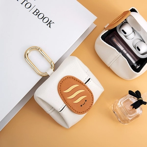 Mini cream leather storage pouch with bread embroidery and metal clasp for lipstick