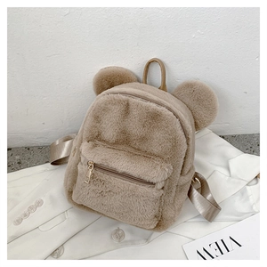 Detail of khaki plush backpack featuring cute round bear ears and a front zipper pocket