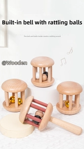 Macro detail of natural wooden baby rattles showing smooth finish and internal bells