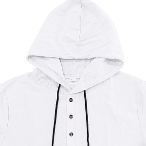 Close-up of white linen shirt collar featuring three wooden buttons and black drawstrings