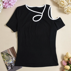 Detailed view of black short sleeve top featuring asymmetric cutout neckline and white trim