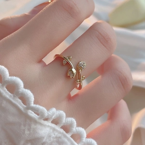 Minimalist gold tulip open ring with pavé micro-diamonds shown on model hand