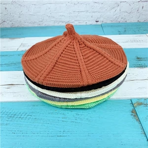 Vertical stack of colorful knit beret hats showing textured vertical stripe patterns
