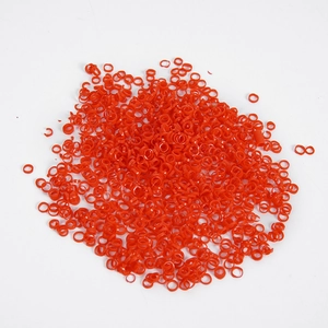 Miniature PVC chili rings and red food accessories for DIY crafts on white background