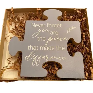 Engraved wooden puzzle piece gift in a craft paper box with inspirational message