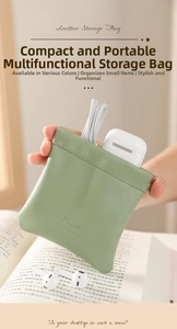 Detail of light green leather pouch with squeeze closure for earphones and small items