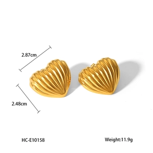 Detail showing 2.87cm x 2.48cm dimensions of gold heart stud earrings with linear texture