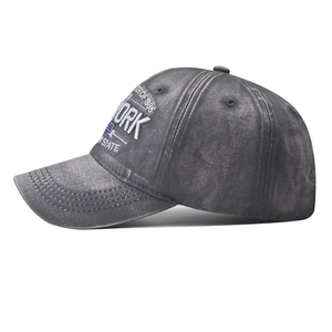 Detailed side view of vintage washed dark gray baseball cap with white 3D embroidery
