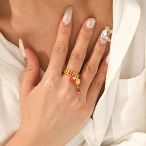 Golden chain ring with shell pearl and red coral charms on hand for ocean vacation style