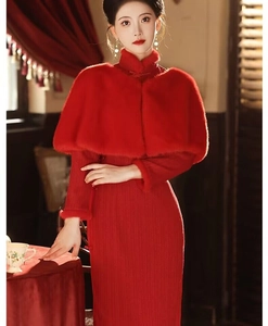 Detail of red faux fur shawl paired with traditional qipao and vintage clasp