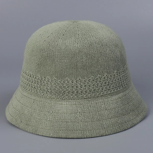 Detail of light green breathable knitted bucket hat with hollow woven texture for women