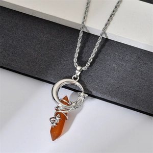 Detail of silver wire-wrapped orange tiger eye stone pendant with moon and star motifs