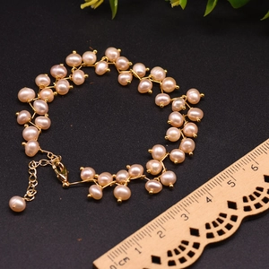 Multi-layer pink freshwater pearl bracelet with gold chain and ruler for size scale