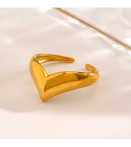 Macro shot of minimalist gold V-shaped open ring with a polished metallic finish